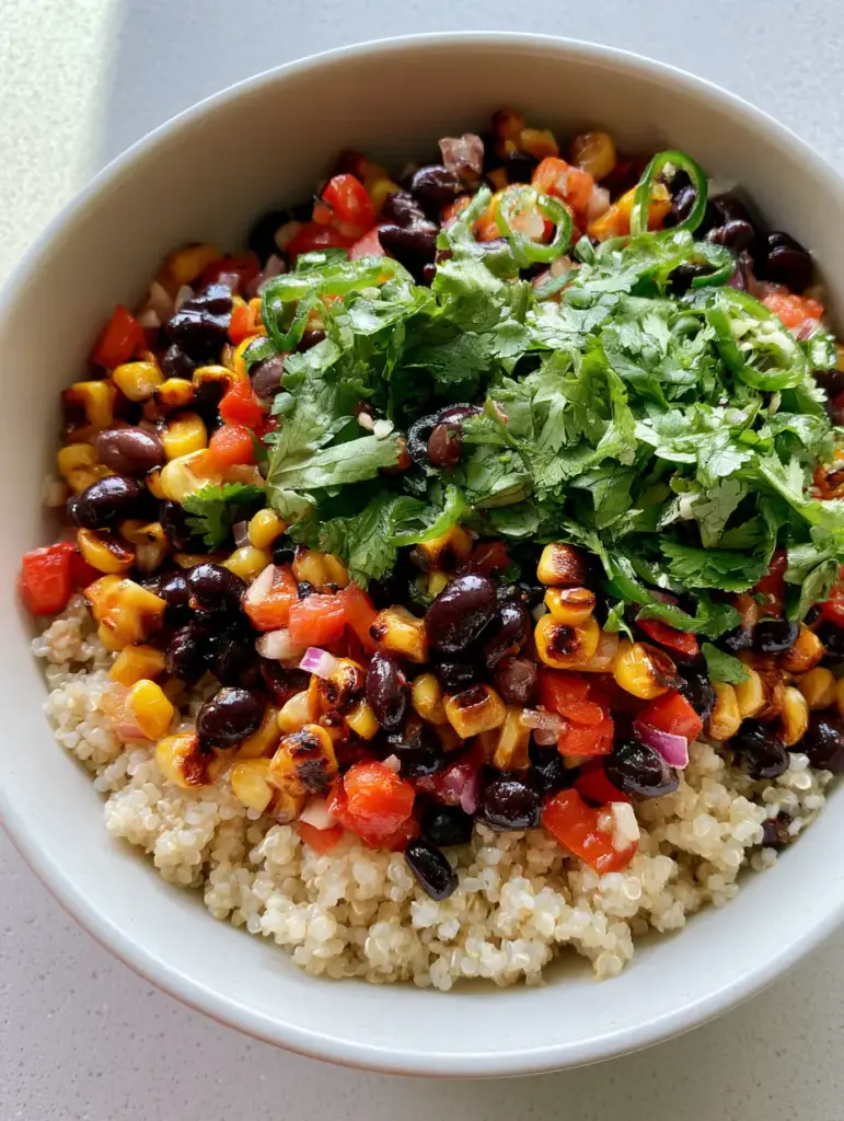 Authentic mobile photography of a Quinoa Black Bean Salad featuring charred corn kernels and a heavy garnish of cilantro.