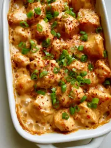 Close up of glossy light tan peanut sauce bubbling on Creamy Peanut Chicken.