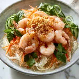 Close-up of translucent mung bean glass noodles and succulent shrimp with fresh herbs and crushed peanuts. (Vietnamese glass noodle salad)