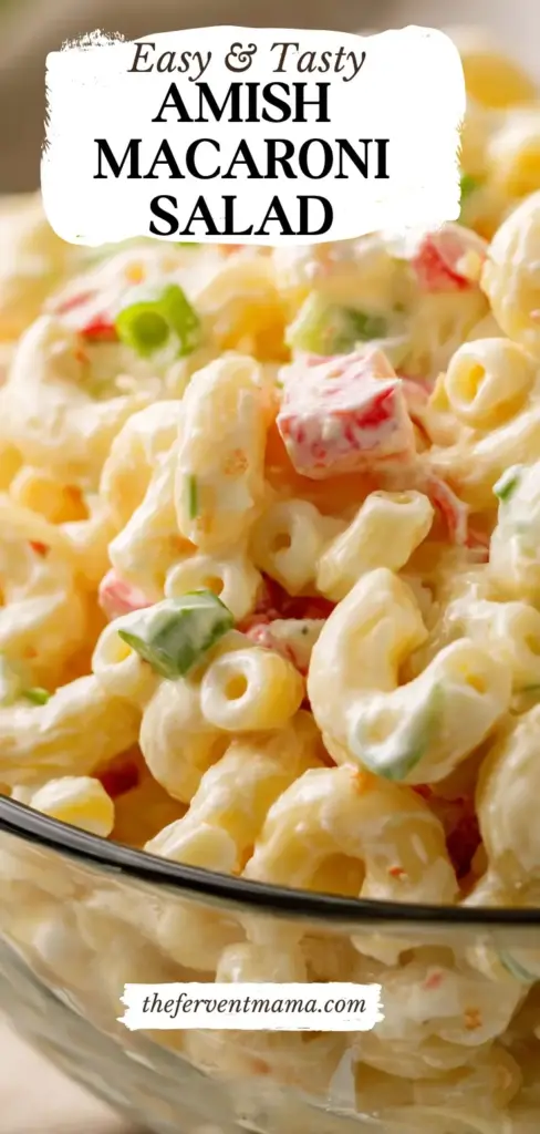 Amish Macaroni Salad: The Ultimate Creamy Classic 3 A tall Pinterest pin showing a close-up of Amish Macaroni Salad in a white bowl with red peppers and green onion garnish.