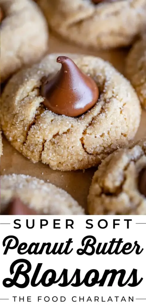 Peanut Butter Blossoms: The Ultimate Soft and Chewy Classic Cookie 4 A stack of Peanut Butter Blossoms with sparkly sugar coating and milk chocolate kisses on a neutral white background.