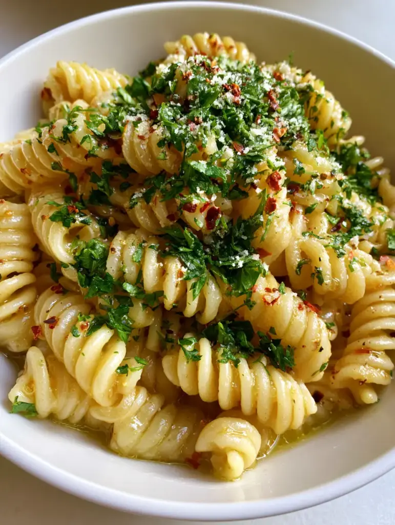 One Pot Garlic Butter Pasta: The Easiest 15-Minute Dinner 2 Close-up high-angle shot of One Pot Garlic Butter Pasta showing glossy rotini spirals and fresh parsley.