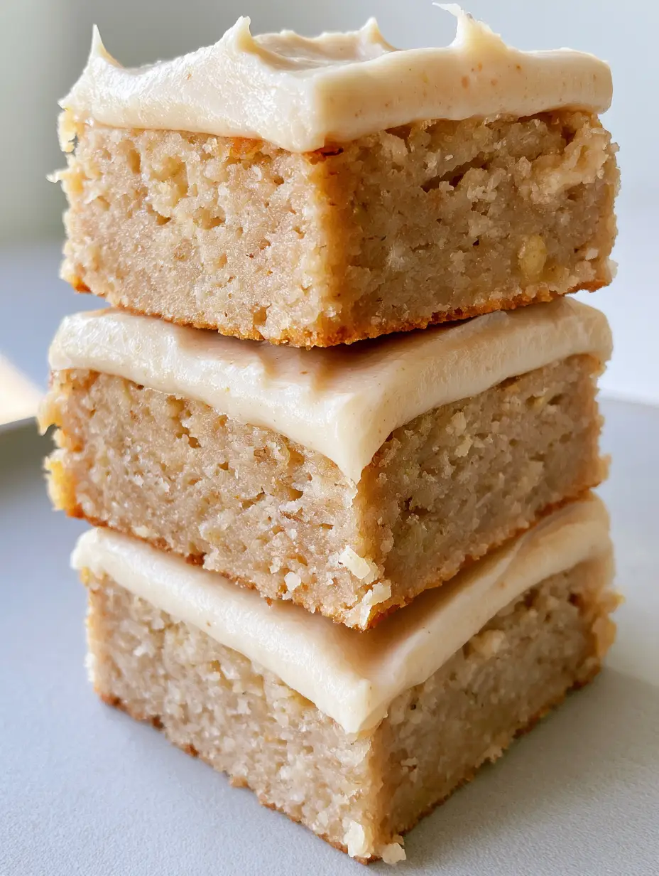 Banana Bread Brownies with Creamy Vanilla Frosting 3 Close up of a moist Banana Bread Brownie showing the dense blondie-style crumb and tiny banana flecks.